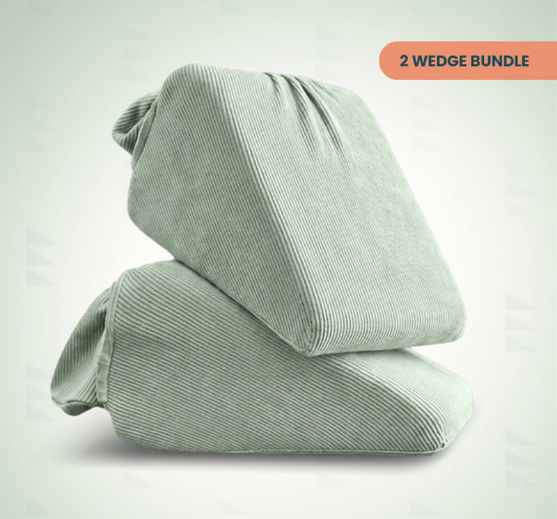 Two light sage green ribbed wedge support pillows stacked together on a light gray background, with an orange label in the top right reading '2 WEDGE BUNDLE'.