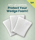 Three white textured wedge foam protectors arranged in an overlapping fan shape against a pale green background with promotional text reading 'SPIT-UP HAPPENS. Protect Your Wedge Foam!' and a yellow '3pk' corner badge.