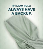 Acute Baby Co. folded ribbed knit garment in a pale sage green color, shown with a dark teal text overlay that reads '#1 MOM RULE: ALWAYS HAVE A BACKUP.' on a light off-white background with a subtle repeating watermark pattern.