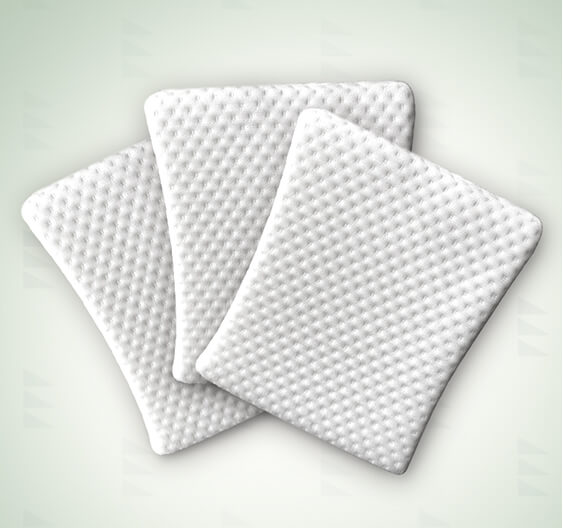 Three white textured jaquard pillow waterproof liners for the acute baby co wedge arranged in a fan shape on a light green background.