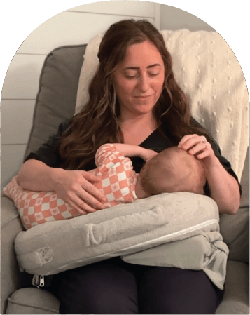 Mom using The Wedge while feeding baby