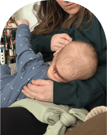 Mom using The Wedge while feeding baby