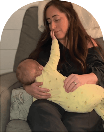Mom using The Wedge while feeding baby