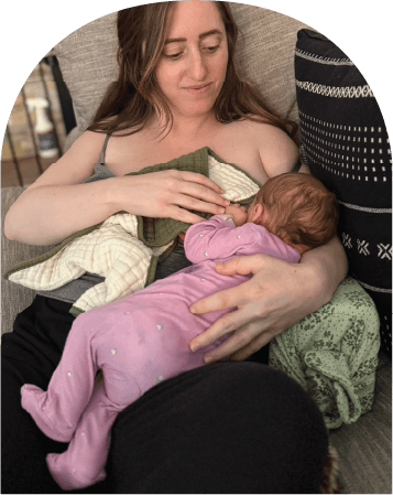 Mom using The Wedge while feeding baby