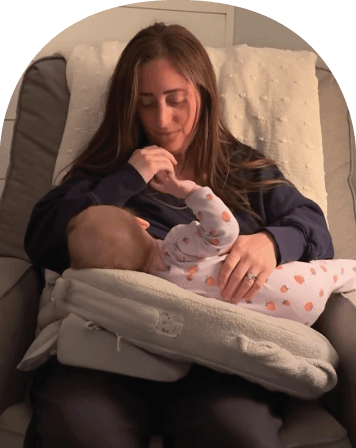 Mom using The Wedge while feeding baby