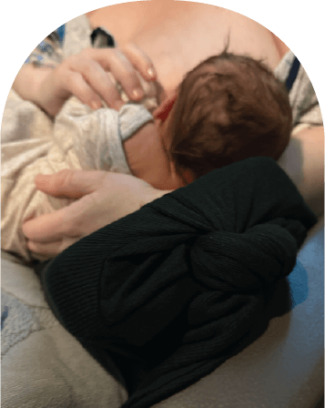 Mom using The Wedge while feeding baby